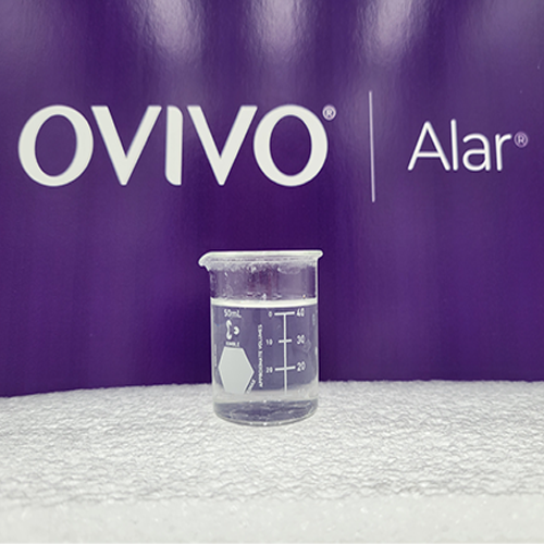 Beaker containing a sample of wastewater treated with ALAR Clear-Aid 1000 wastewater flocculant.